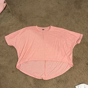 This is a pink baggy cropped shirt.